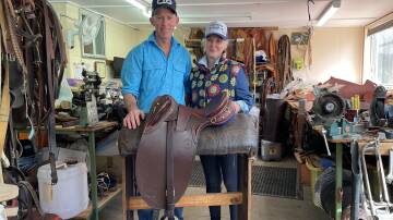 Glenn and Victoria Davis in Glenn's workshop with a Stockman's Throne saddle. Picture by Simon Chamberlain