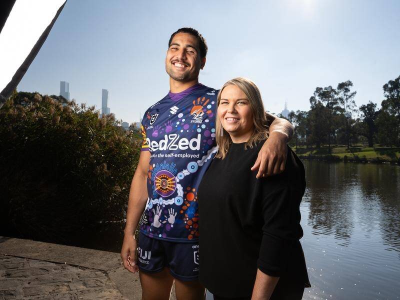 Reimis Smith proudly wears Melbourne's Indigenous jersey designed by his cousin Letitia Smith (r). (HANDOUT/Melbourne Storm)